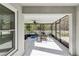 Screened porch with seating area and ceiling fan at 18236 Holland House Loop, Land O Lakes, FL 34638