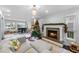 Living room featuring fireplace, Christmas tree, piano, and large windows at 4403 W Platt St, Tampa, FL 33609