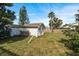 White shed in backyard with grassy area and trees at 4481 Alligator Dr, New Port Richey, FL 34653