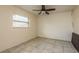 Bedroom with ceiling fan and tile floors at 4481 Alligator Dr, New Port Richey, FL 34653