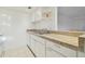 White kitchen with granite countertops and sink at 4715 Michael Ct # 136, Tampa, FL 33614