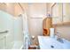 Clean bathroom with a shower/tub combo and wood cabinet at 4961 Britni Way, Zephyrhills, FL 33541