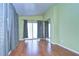 Large bedroom with wood-look flooring and sliding glass doors at 4961 Britni Way, Zephyrhills, FL 33541
