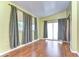 Spacious bedroom with wood-look flooring and light green walls at 4961 Britni Way, Zephyrhills, FL 33541