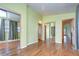 Bright bedroom with wood-look flooring and mirrored closet doors at 4961 Britni Way, Zephyrhills, FL 33541