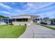 Nice yellow single-wide manufactured home with carport and landscaping at 4961 Britni Way, Zephyrhills, FL 33541