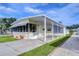 View of a yellow single-wide manufactured home with covered carport at 4961 Britni Way, Zephyrhills, FL 33541