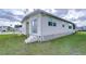 Side view of a mobile home with exterior access at 4961 Britni Way, Zephyrhills, FL 33541