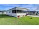 Front view of a mobile home with covered porch at 4961 Britni Way, Zephyrhills, FL 33541