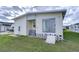 Rear view of a mobile home with sliding glass doors at 4961 Britni Way, Zephyrhills, FL 33541