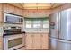 Kitchen boasts stainless steel appliances and ample cabinet space at 4961 Britni Way, Zephyrhills, FL 33541
