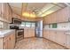 Updated kitchen with stainless steel appliances and light wood cabinets at 4961 Britni Way, Zephyrhills, FL 33541