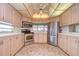 Modern kitchen with stainless steel appliances and light wood cabinets at 4961 Britni Way, Zephyrhills, FL 33541