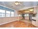 Open kitchen with stainless steel appliances and wood flooring at 4961 Britni Way, Zephyrhills, FL 33541