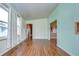 Spacious living room featuring wood flooring and an open floor plan at 4961 Britni Way, Zephyrhills, FL 33541