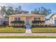 Charming yellow bungalow with manicured landscaping and a brick walkway at 5226 3Rd N Ave, St Petersburg, FL 33710