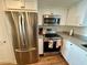 Stainless steel appliances and white shaker cabinets highlight this kitchen at 7050 Sunset S Dr # 1507, South Pasadena, FL 33707