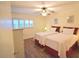 Cozy bedroom with two twin beds, ceiling fan, and ample natural light at 920 Virginia St # 204, Dunedin, FL 34698