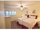 Cozy bedroom with two twin beds, ceiling fan, and ample natural light at 920 Virginia St # 204, Dunedin, FL 34698