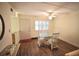 Dining area with a glass-top table and four chairs and wood-look flooring at 920 Virginia St # 204, Dunedin, FL 34698