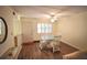 Dining area with glass-top table and four chairs and wood-look flooring at 920 Virginia St # 204, Dunedin, FL 34698