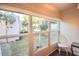 Florida room with large windows offering scenic views of the surrounding area at 920 Virginia St # 204, Dunedin, FL 34698