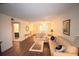 Living room with a tan couch, coffee table, and wood-look floors at 920 Virginia St # 204, Dunedin, FL 34698