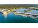 Aerial view of a waterfront area with a bridge, docks, and residential properties at 100 Bluff View Dr # 207C, Belleair Bluffs, FL 33770