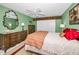 Comfortable bedroom featuring a ceiling fan, dresser, and ample closet space at 100 Bluff View Dr # 207C, Belleair Bluffs, FL 33770