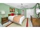 Bedroom with decorative mirror, ensuite bathroom, and painting at 100 Bluff View Dr # 207C, Belleair Bluffs, FL 33770