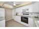 White kitchen with modern appliances, ample counter space, and plenty of cabinets at 100 Bluff View Dr # 207C, Belleair Bluffs, FL 33770