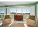 Cozy living room with armchairs and a water view from the windows at 100 Bluff View Dr # 207C, Belleair Bluffs, FL 33770