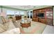 Living room with comfortable seating, an entertainment unit and view at 100 Bluff View Dr # 207C, Belleair Bluffs, FL 33770
