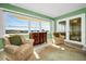 Cozy living room with two arm chairs, a view and french doors at 100 Bluff View Dr # 207C, Belleair Bluffs, FL 33770