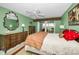 Bright main bedroom with large mirror, ceiling fan, and access to outdoor balcony at 100 Bluff View Dr # 207C, Belleair Bluffs, FL 33770