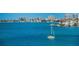 Sailboat on the tranquil blue water with a cityscape in the background at 100 Bluff View Dr # 207C, Belleair Bluffs, FL 33770
