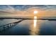 Spectacular sunset over the ocean with a bridge and coastal homes in the foreground at 100 Bluff View Dr # 207C, Belleair Bluffs, FL 33770