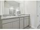 Modern bathroom with granite countertop and double sinks at 10058 Shoreline View Way, Wesley Chapel, FL 33545