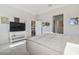 Bright bedroom with TV stand and ensuite access at 10058 Shoreline View Way, Wesley Chapel, FL 33545