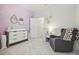 Bedroom with changing table and armchair at 10058 Shoreline View Way, Wesley Chapel, FL 33545
