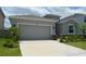 Beautiful home featuring an attached two-car garage, well-kept lawn, and attractive landscaping at 10058 Shoreline View Way, Wesley Chapel, FL 33545