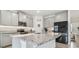 Modern kitchen with granite countertops, gray cabinets, and stainless steel appliances at 10058 Shoreline View Way, Wesley Chapel, FL 33545