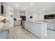 Spacious kitchen with island, stainless steel appliances, and granite countertops at 10058 Shoreline View Way, Wesley Chapel, FL 33545