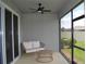Cozy screened-in lanai with a ceiling fan, patio furniture, and privacy at 10058 Shoreline View Way, Wesley Chapel, FL 33545