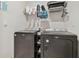 Convenient laundry room with washer, dryer, and shelving at 10058 Shoreline View Way, Wesley Chapel, FL 33545