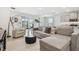 Comfortable living area featuring a sectional sofa and sliding door access to patio at 10058 Shoreline View Way, Wesley Chapel, FL 33545