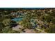 Aerial view of community with tennis courts, pool, and clubhouse at 1012 Osprey Ct, Tarpon Springs, FL 34689