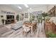 Open concept dining area with a rustic table and living room view at 1012 Osprey Ct, Tarpon Springs, FL 34689