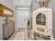 Bright entryway with hardwood floors, antique cabinet, and wood mirror at 1012 Osprey Ct, Tarpon Springs, FL 34689