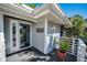 Inviting front porch with glass door entry and a welcome sign at 1012 Osprey Ct, Tarpon Springs, FL 34689